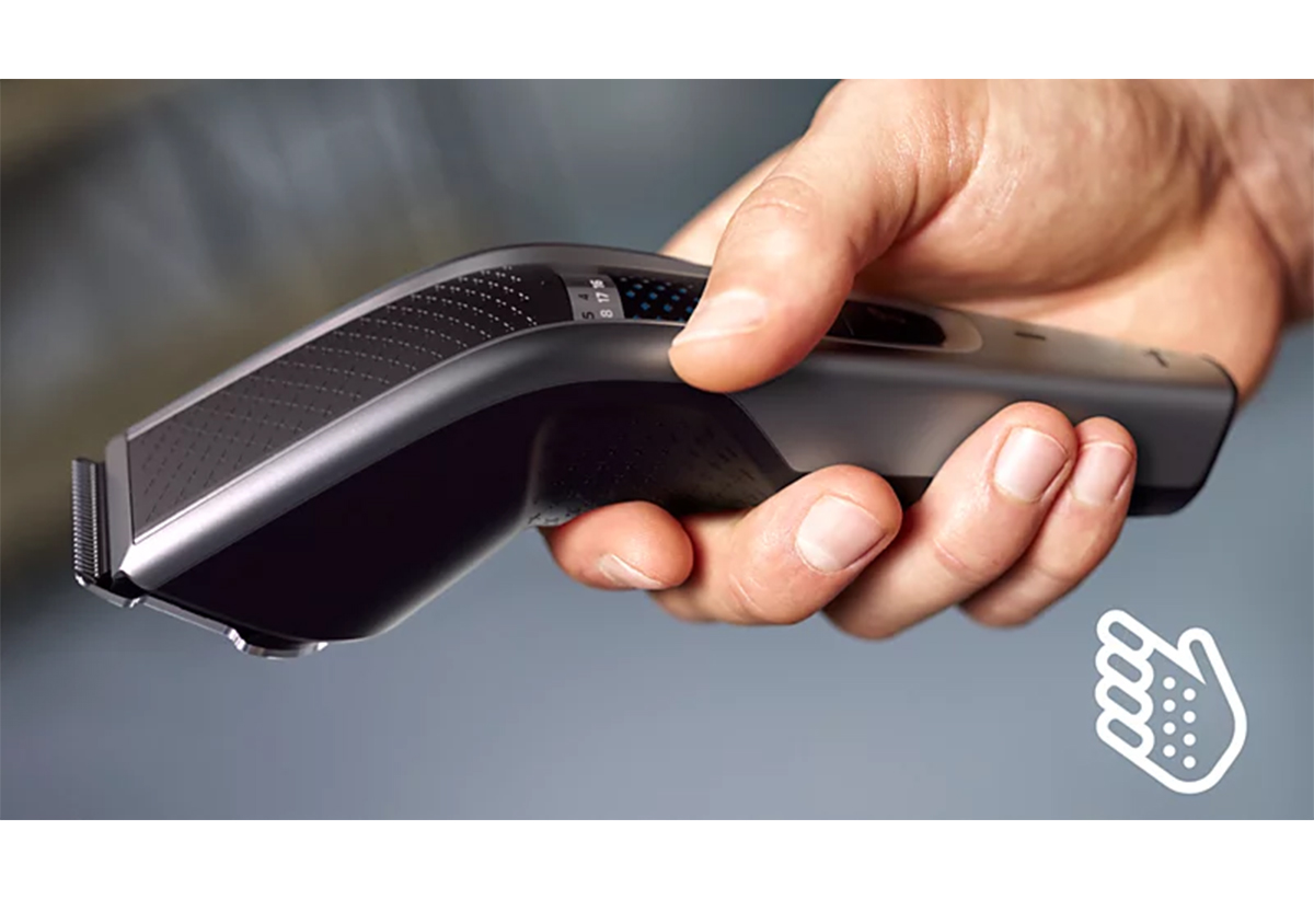 Απεικονίζεται ένας άνδρας να κρατά τη μηχανή στο χέρι του.